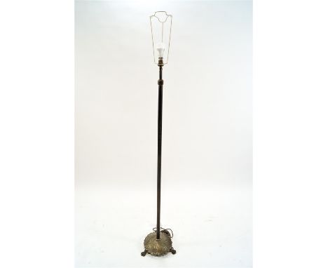 A brass standard lamp with fluted column on round base on three paw feet, 41cm high