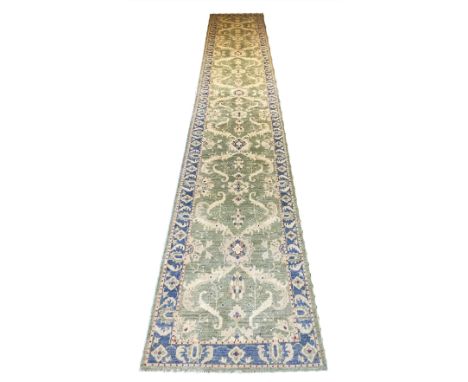 FINE ZIEGLER RUNNER, 492cm x 80cm, all over palmette and vine design on a jade field within a complimentary powder blue borde