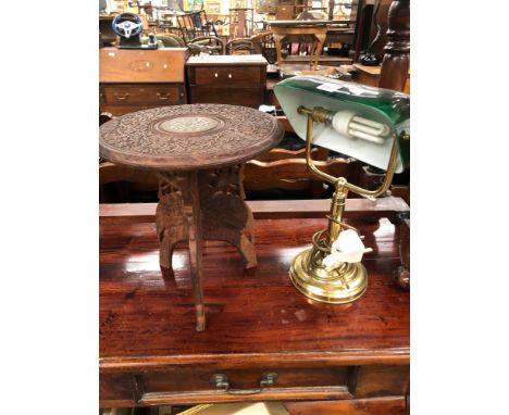 A BRASS TABLE LAMP WITH ADJUSTABLE GREEN GLASS SHADE TOGETHER WITH AN ISLAMIC CARVED WOOD SMALL TABLE