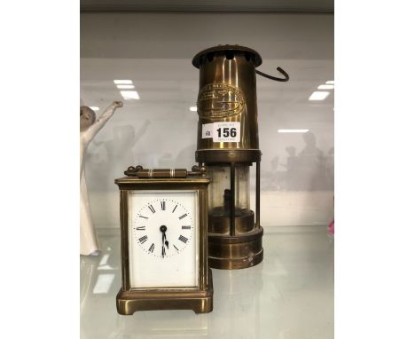 A THOMAS &amp; WILLIAMS MINERS LAMP TOGETHER WITH A CARRIAGE TIMEPIECE