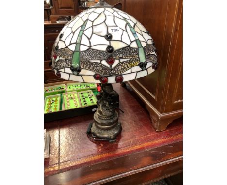 A TABLE LAMP WITH TIFFANY STYLE DRAGON FLY LEADED GLASS SHADE TOGETHER WITH A THRE LIGHT TABLE LAMP WITH A SCANTILY DRAPED LA