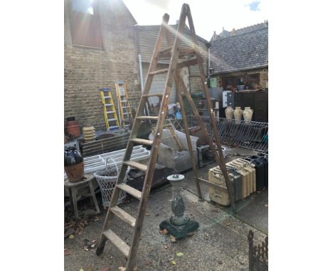 A LARGE WOODEN STEP LADDER
