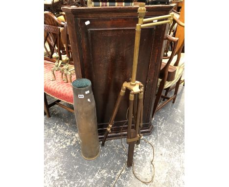 A BRASS ADJUSTABLE STANDARD LAMP, A SHELL CASE  TOGETHER WITH THREE BRASS FIRE IRONS