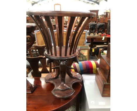 A VICTORIAN MAHOGANY PLANTER CRADLE SUPPORTED ON THREE DOLPHINS HEADS, THEIR TAILS ON A PLINTH WITH THREE FEET