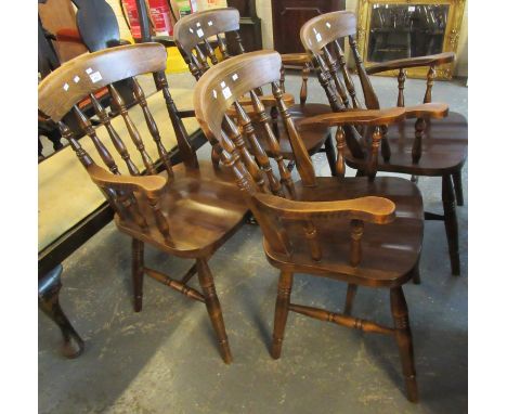 A set of four 20th Century stained spindle back kitchen elbow or armchairs on turned legs and stretchers, together with a cam