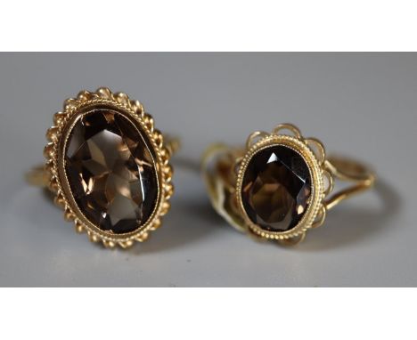 Two 9ct gold smokey quartz rings. Both size M. Approx weight 6.1 grams. (B.P. 21% + VAT) Jewellery valuer not available so ge