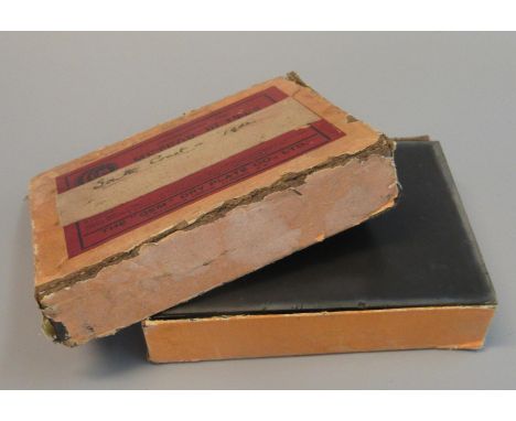 A boxed set of glass photographic plates titled 'South Coast 1902', listing in order 'Parade, Brighton', 'Beach, South Sea', 
