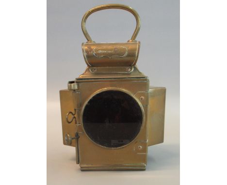 Early 20th Century brass 'Dependence' vehicle lamp having red main lens with two angled clear lenses, fixing bracket and loop
