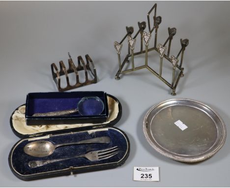 Victorian silver coaster, together with a silver four section toast rack, silver handled magnifying glass, silver plated toas