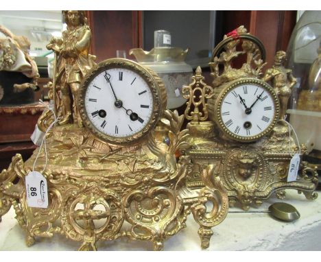 Two similar French gilt spelter drum head shaped mantel clocks, both figure mounted and with scroll work bases, one two train