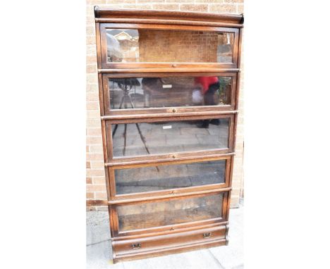 GLOBE WERNICKE OAK FIVE SECTION BOOKCASE, with cornice above five sections, of which three bear a makers plaque/stamp, raised