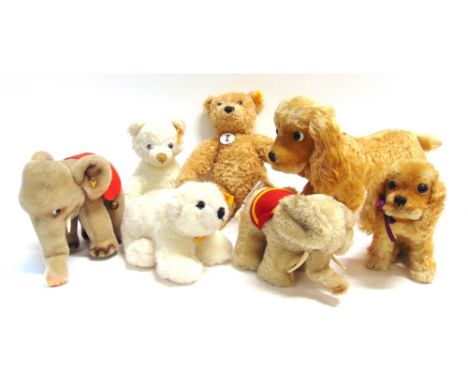 SEVEN SOFT TOYS  comprising a Steiff seated spaniel, 16.5cm high; Steiff elephant, 16.5cm high; and five others.