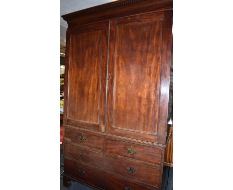 19TH CENTURY MAHOGANY LINEN PRESS, the moulded cornice above two cupboard doors opening to reveal four sliding shelves, with 