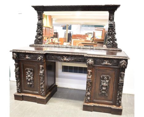 19TH CENTURY BREAKFRONT KNEEHOLE PEDESTAL SIDEBOARD, with a raised mirror back with a carved surround, above a central drawer