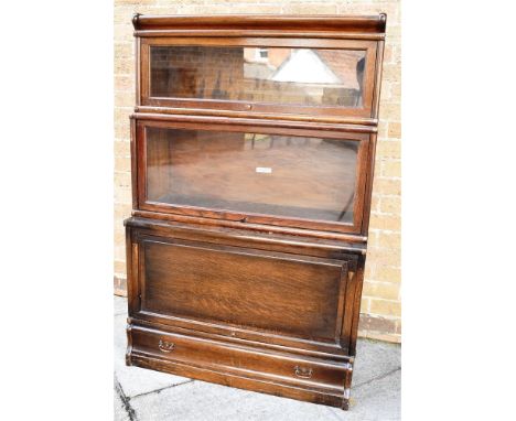 GLOBE WERNICKE OAK THREE SECTION GRADUATED BOOKCASE, with cornice above two sections with glazed doors and one bearing the ma