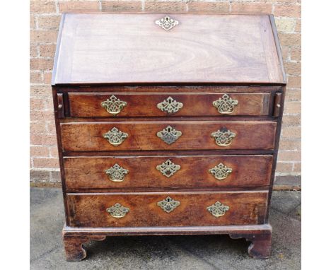 19TH CENTURY MAHOGANY BUREAU, the fall front opening to reveal a writing surface and fitted compartments above four long grad