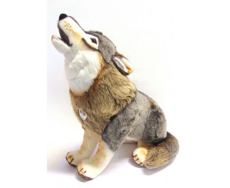 A STEIFF WOLF SOFT TOY,  in a seated, howling pose, 63cm high.