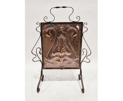 Art Nouveau firescreen, the central copper panel with repousse stylised flower decoration held within a wrought iron scrollwo