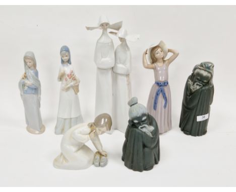 Group of Lladro figures, including a figure group of two nuns, 32.3cm high, two figures of girls carrying baskets of flowers,