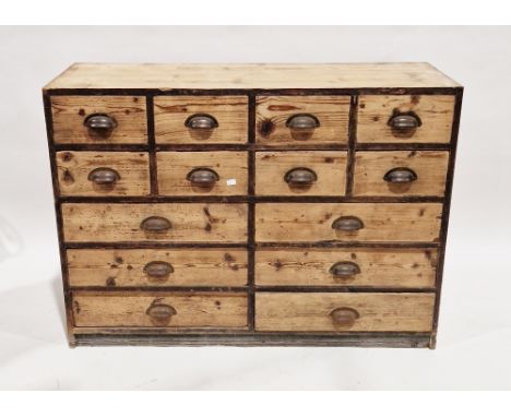 Early 20th century industrial pine chest comprising a bank of 13 drawers, each with iron cup handles, 84cm high x 115cm wide 