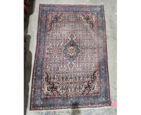 Persian-style cream ground rug&nbsp;with central floral medallion on interwoven floral field, floral spandrels, multiple flor