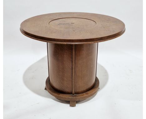 Art Deco oak circular cocktail table, the top with central pop-up section revealing white bakelite trays and a shelf, on a ci