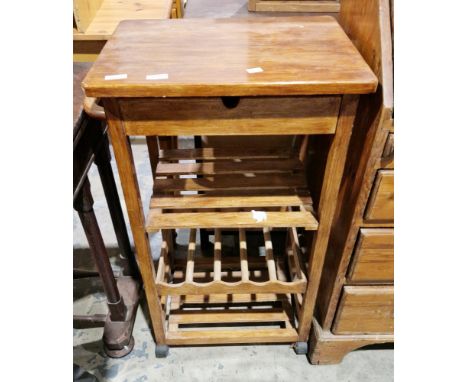 Modern stained wooden kitchen trolley&nbsp;with single drawer, towel rail, two slatted shelves and a wine bottle shelf, on ca