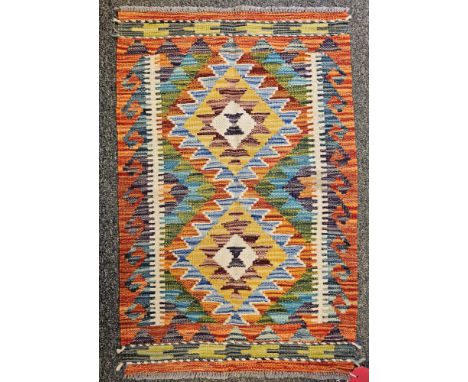 Chobi Kilim orange ground rug with two central lozenge medallions flanked by single geometric border 86cm x 56cm