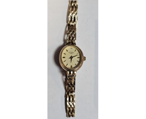 Rotary 9ct gold wristwatch, the oval face with baton markers on a three bar gate-link strap, with spare link and Rotary guara