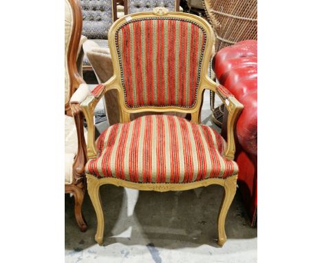 French open armchair in the Louis XV manner with a gilded finish, green and red striped upholstery, on cabriole legs, 91cm hi