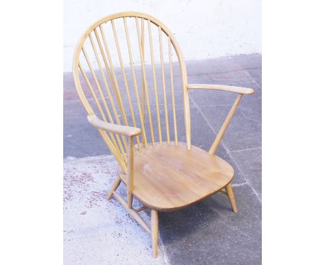An Ercol light elm and beech arm chair. W74cm H95cm