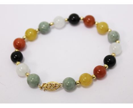 A multi-coloured jade bracelet with 14k gold clasp