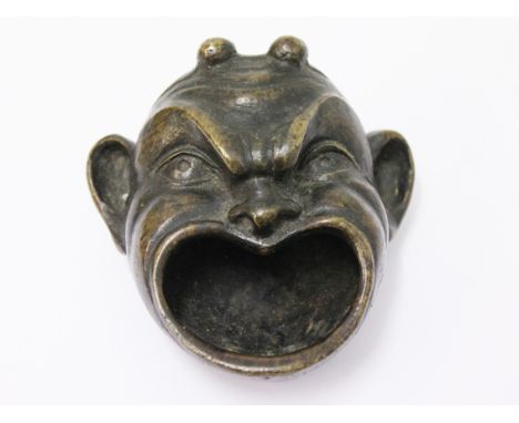 An Eastern grotesque bronze mask cup. L9cm