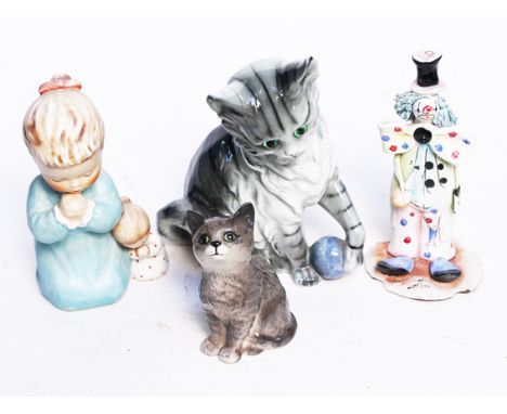 A mixed lot comprising a Goebel figure, a Beswick cat, another cat and a clown figure