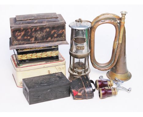 A mixed lot comprising four tins, a miners lamp, a horn, opera glasses etc.