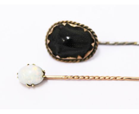 Two yellow metal stick pins, one inset with an opal the other a scarab