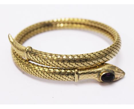 A yellow metal serpant bangle. Diam. 6cm