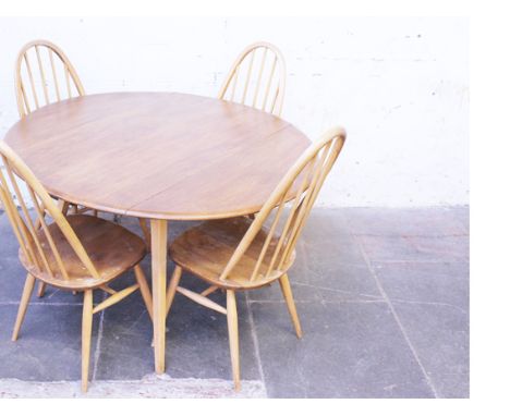 An Ercol light elm beech table and chairs