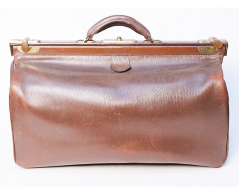 A vintage leather Gladstone bag