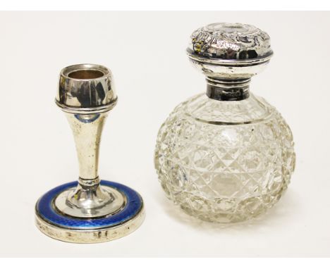 A hallmarked silver and enamel candlestick together with a hallmarked silver topped jar