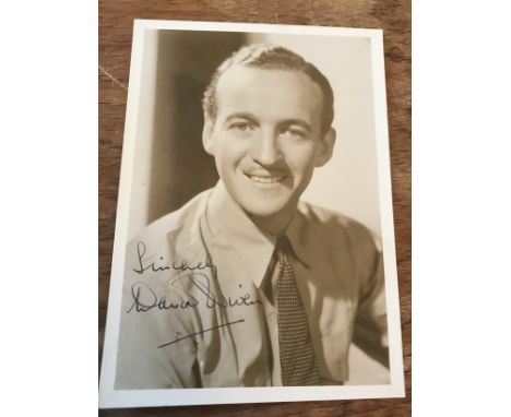 David Niven signed 7 x 5 inch sepia portrait photo. Good condition. All autographs come with a Certificate of Authenticity. W
