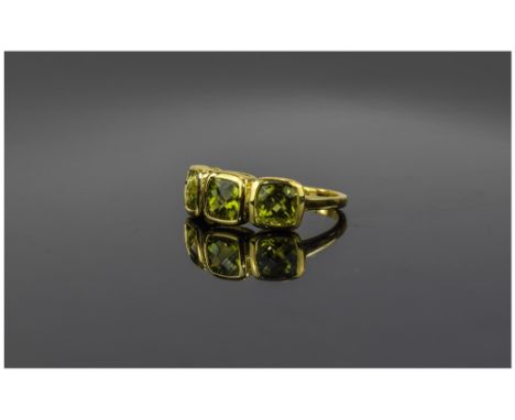 Peridot Three Stone Ring, three cushion cut peridots, bezel set in a row in 14ct gold vermeil and silver, totalling 2.75cts; 