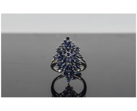 Sapphire Cluster Ring, 4.8cts of marquise cut blue sapphires, centred by a similar round cut, forming a marquise shaped clust