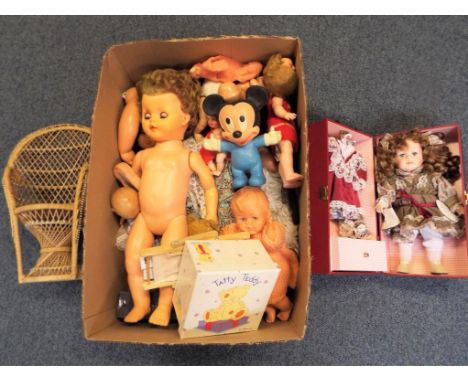A good lot to include a quantity of vintage dolls, a Walt Disney Mickey Mouse toy and a Leonardo Collection porcelain doll in