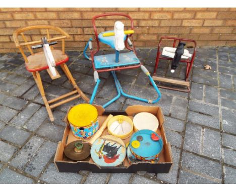 A good lot to include three child's vintage rocking horses and box of tinplate drums, tambourines and similar.
