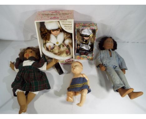 Dolls -  a quantity of dolls comprising a porcelain doll from the Knightsbridge Collection, a musical wind-up animated doll, 