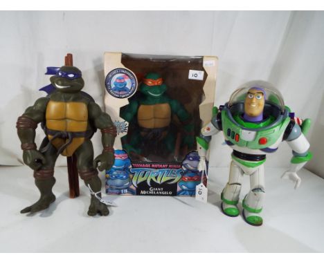 A Teenage Mutant Ninja Turtle by Playmates entitled Giant Michelangelo in original box, a Toy Story vintage Buzz Lightyear an