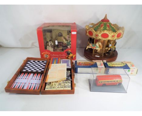 A good mixed lot to include a model of a carousel, a Wallace and Gromit talking radio alarm clock in original box, a games se