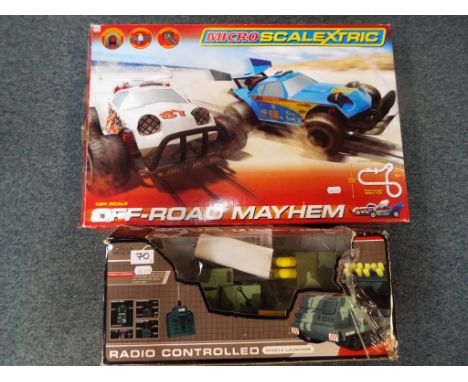 A boxed Micro Scalextric 1:64 scale Off Road Mayhem set and a radio controlled Missile Launcher (2)