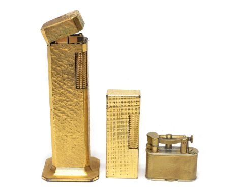 Three Gilt metal Dunhill lighters Three gilt metal Dunhill lighters to include a 'Tallboy' with a textured finish case, a mac